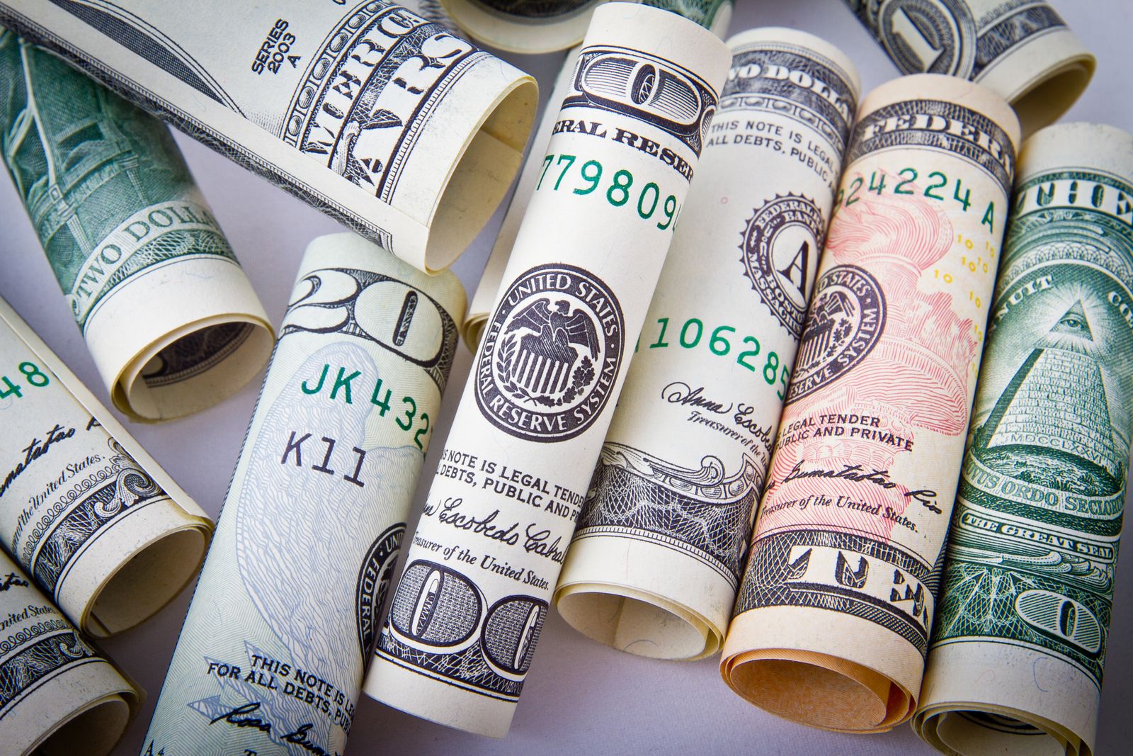 Rolled U.S. dollar bills of various denominations