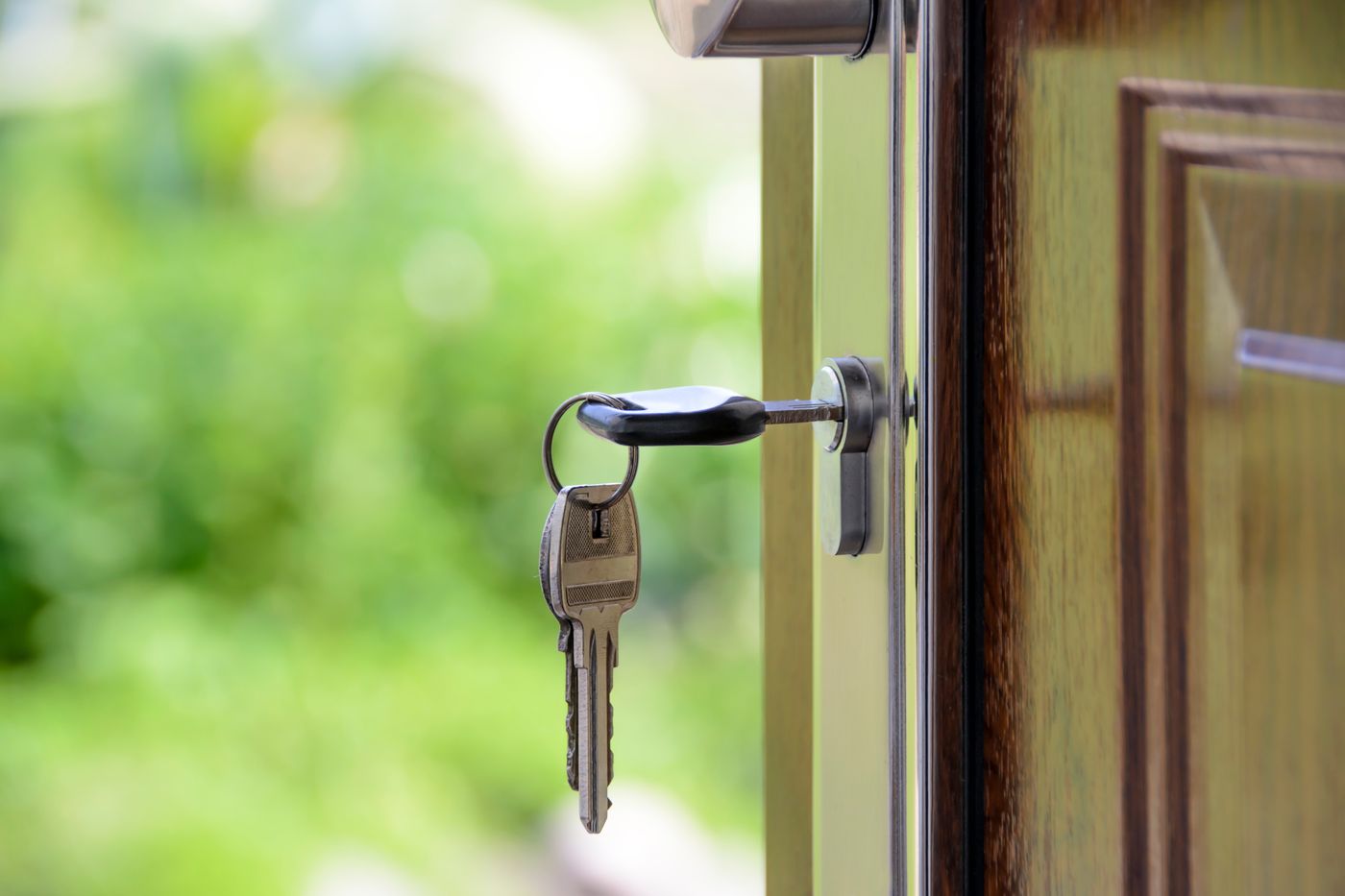 House keys hanging in the lock of an open front door