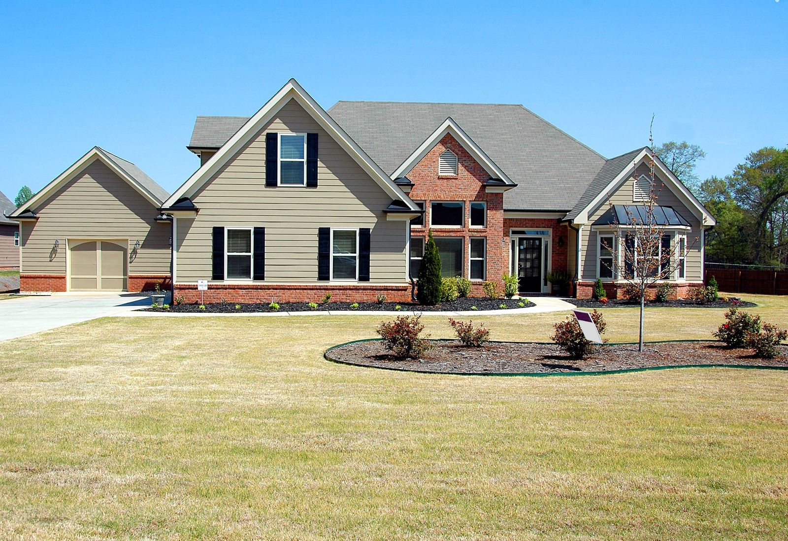A suburban family house with a large front lawn and driveway